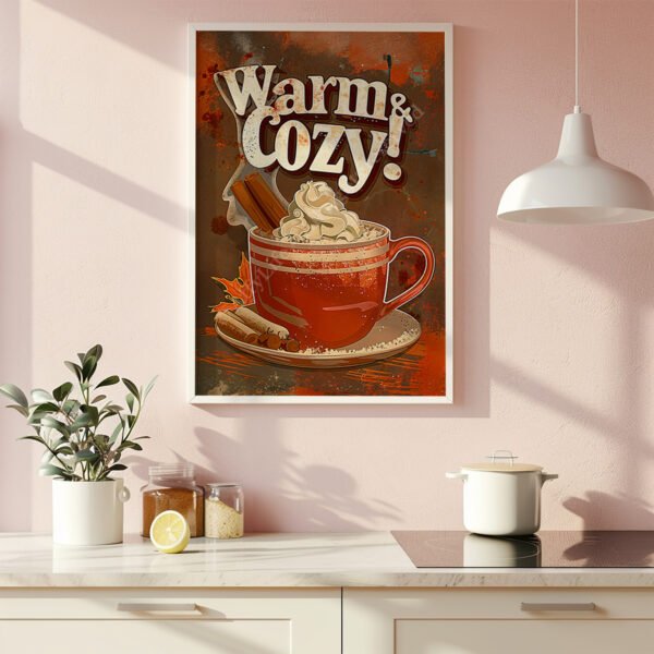 Framed Retro Hot Chocolate Poster of a red mug with whipped cream and cinnamon sticks, labeled "Warm & Cozy!" on a pink wall.