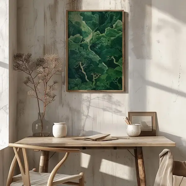 A sunlit room with a wooden desk, notebook, and vase beneath a framed Serene Sage Green Japandi Wall Art. Dried branches and soft shadows enhance the calm, earthy atmosphere.