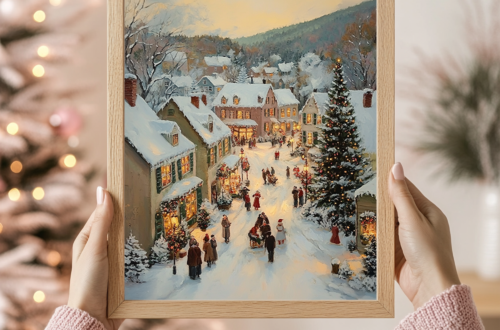 Woman holding a wooden-framed Christmas Village art with glowing holiday lights in the background. Cozy festive vibes.