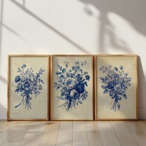 Three framed Antique Blue Toile Prints of delicate blue floral bouquets on a beige background. Sunlight casts geometric window shadows across the wooden floor, creating a serene, timeless look.