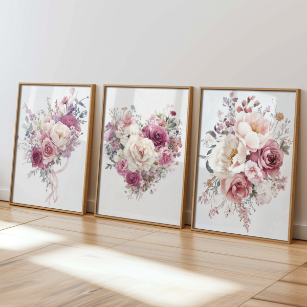 Three pastel floral bouquet posters in light wooden frames are displayed on a wooden floor against a light wall. They are perfect for romantic Valentine’s Day decor or coquette-inspired spaces.