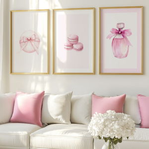 Pink Coquette Wall Art Set: Three gold frames are above a white sofa with white and pink pillows. The perfume, macarons, and powder puffs add a chic, romantic vibe.