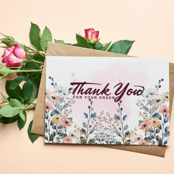 A thank-you card with pink roses and a floral design was placed in a brown envelope. The text reads "Thank You for Your Order" in elegant script.