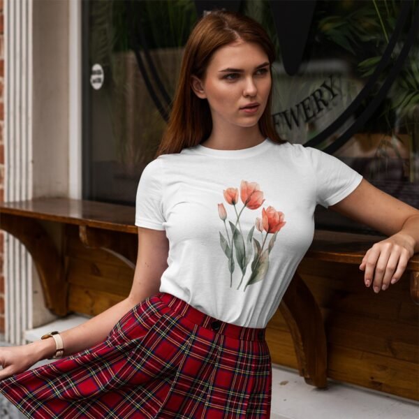 A woman wearing a white t-shirt with orange tulips and a red plaid skirt, standing thoughtfully in front of a shop window.