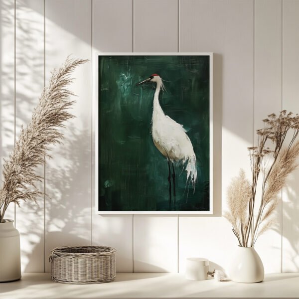 A framed Japanese Crane Art painting of a white crane on a green background is displayed on a white paneled wall. Sunlit pampas grass decorates the serene setting, enhancing the natural aesthetic.