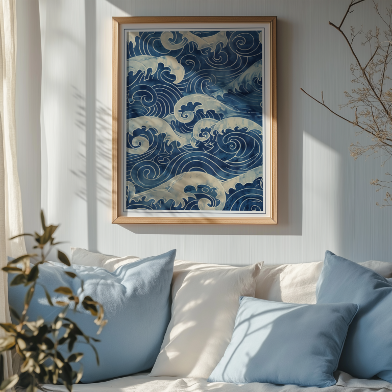 Framed Blue Japandi Wave Wall Art of swirling blue ocean waves hanging above a cozy sofa adorned with blue and white pillows. Sunlight and soft shadows enhance the calm, serene ambiance of the room.