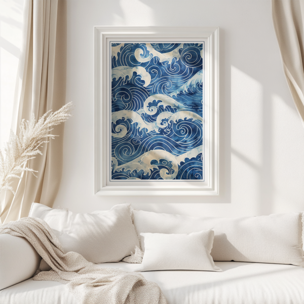 Framed Blue Japandi Wave Wall Art featuring stylized blue ocean waves on a white wall above a cozy white sofa with beige cushions and a textured blanket. Sunlight filters through the space, adding warmth.