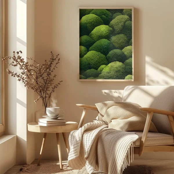 Beige armchair with blanket next to a side table holding a mug and books. Above hangs a framed Japanese Green Wall Art.